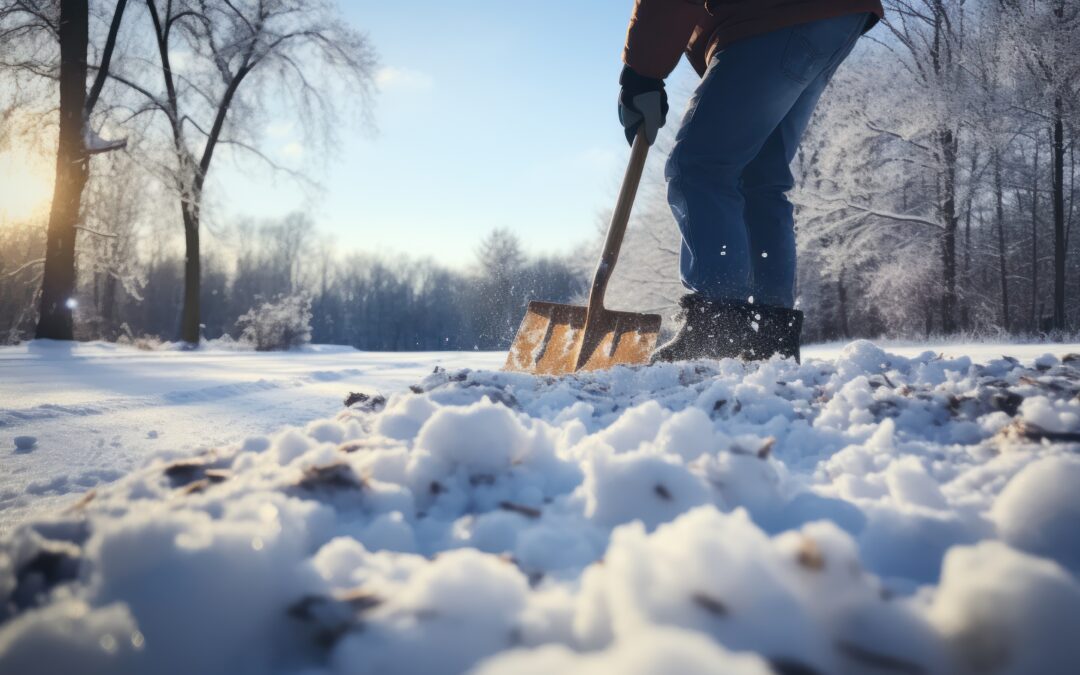 a person using a snow shovel to clear snow